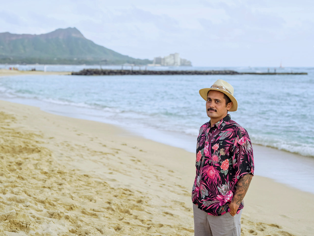 A man wearing Hawaiian Shirt and standing on the beach in Hawaii